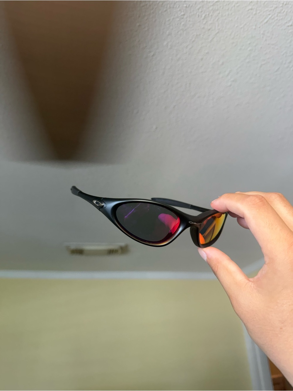 Oakley Black Frame Sunglasses with Red-Orange Mirrored Lenses